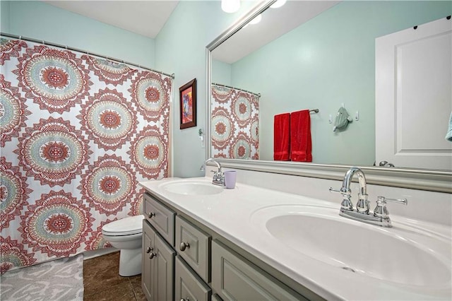 9486 Labrador Run N, Mobile, AL 36695 - bathroom with toilet, double vanity, curtained shower, and tile patterned floors