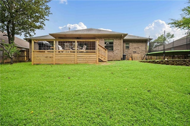 9486 Labrador Run N, Mobile, AL 36695 - rear view of property with a trampoline, a deck, brick siding, and stairs