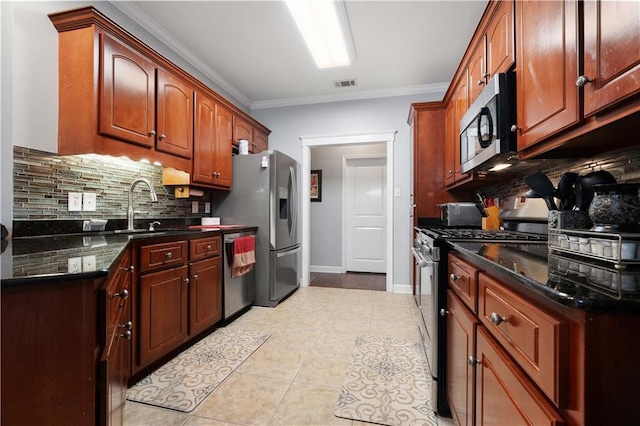 9486 Labrador Run N, Mobile, AL 36695 - kitchen featuring stainless steel appliances, a sink, backsplash, crown molding, and light tile patterned flooring