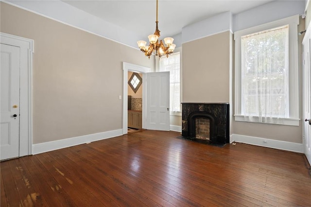 255 N Conception St, Mobile, AL 36603 - unfurnished living room featuring a chandelier, hardwood / wood-style floors, and a fireplace