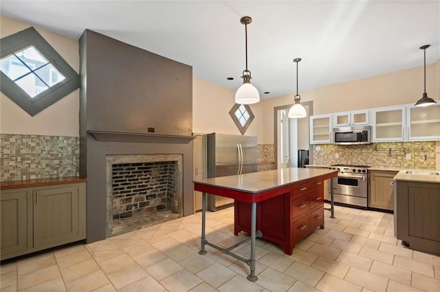 255 N Conception St, Mobile, AL 36603 - kitchen with stainless steel appliances, backsplash, a breakfast bar area, and glass insert cabinets