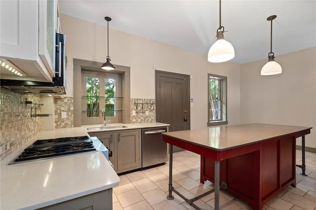 255 N Conception St, Mobile, AL 36603 - kitchen featuring stainless steel appliances, light countertops, tasteful backsplash, and pendant lighting