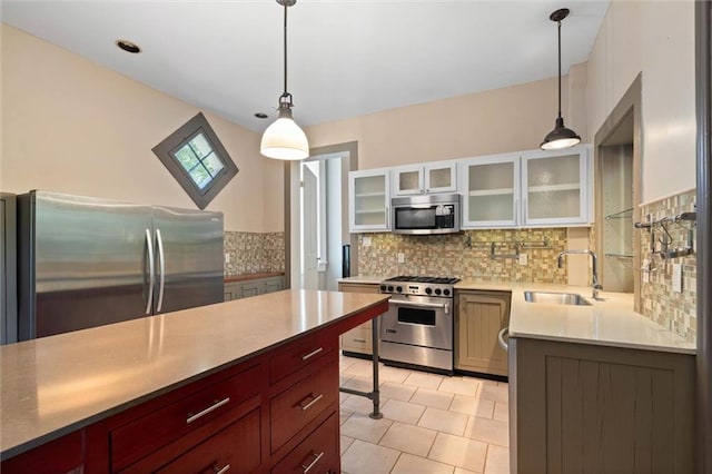 255 N Conception St, Mobile, AL 36603 - kitchen featuring appliances with stainless steel finishes, backsplash, glass insert cabinets, light countertops, and light tile patterned floors