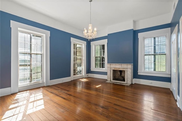255 N Conception St, Mobile, AL 36603 - unfurnished living room with a chandelier, plenty of natural light, and hardwood / wood-style floors