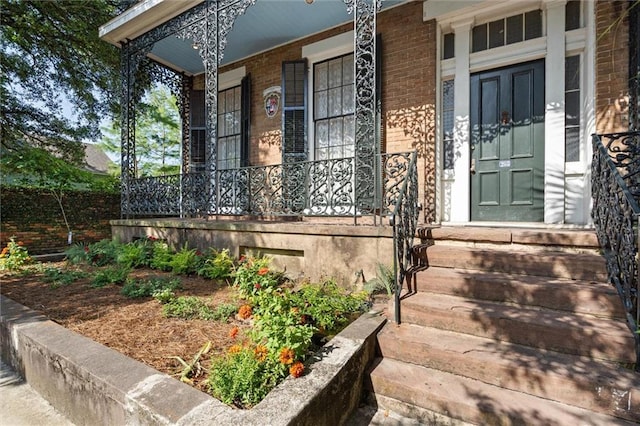 255 N Conception St, Mobile, AL 36603 - doorway to property featuring a porch and brick siding