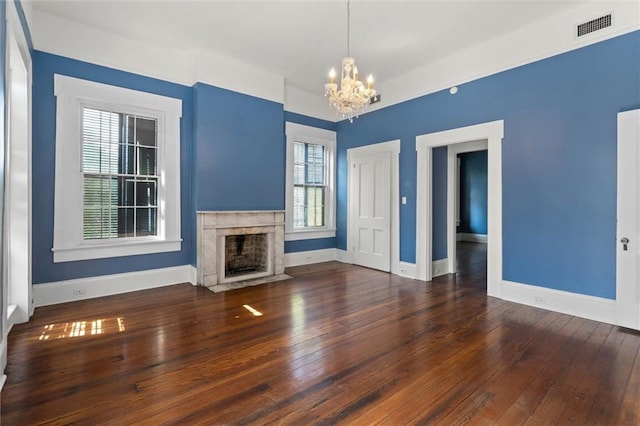 255 N Conception St, Mobile, AL 36603 - unfurnished living room featuring a chandelier, wood-type flooring, and a high end fireplace
