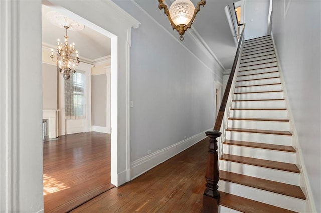 255 N Conception St, Mobile, AL 36603 - stairway featuring a chandelier, wood-type flooring, and crown molding
