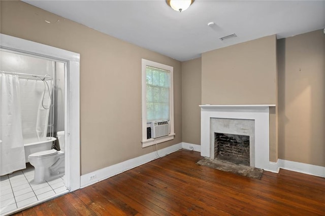 255 N Conception St, Mobile, AL 36603 - unfurnished living room featuring wood-type flooring, a fireplace, and cooling unit