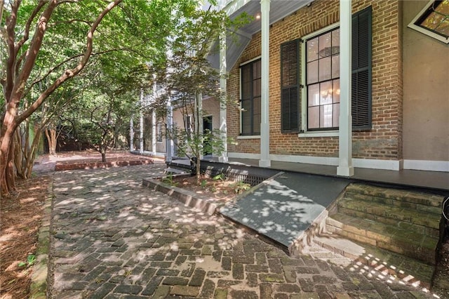 255 N Conception St, Mobile, AL 36603 - view of property exterior featuring brick siding and covered porch