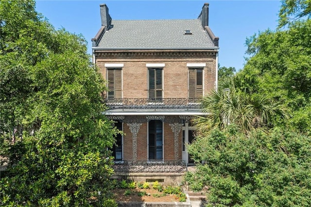 255 N Conception St, Mobile, AL 36603 - view of front of house with covered porch, brick siding, and a chimney