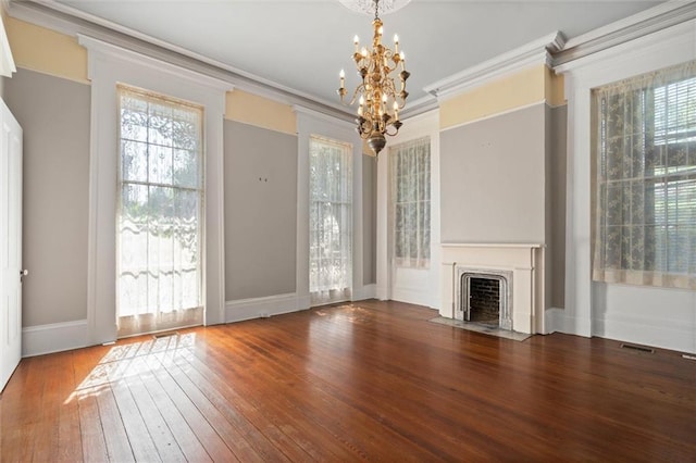 255 N Conception St, Mobile, AL 36603 - unfurnished living room featuring a chandelier, hardwood / wood-style flooring, a fireplace with flush hearth, and ornamental molding