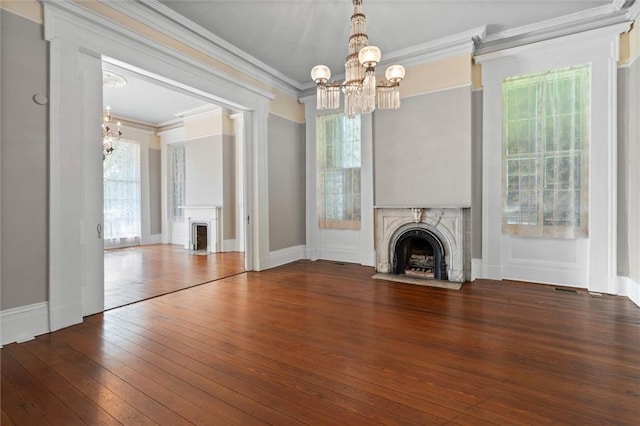 255 N Conception St, Mobile, AL 36603 - unfurnished living room with a fireplace with flush hearth, a chandelier, crown molding, and hardwood / wood-style floors