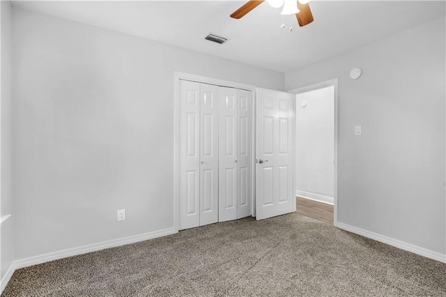 unfurnished bedroom with carpet flooring, a closet, and ceiling fan