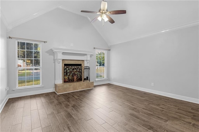 unfurnished living room with a high end fireplace, dark wood-type flooring, ceiling fan, and a healthy amount of sunlight