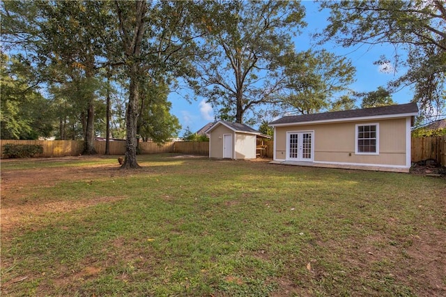 view of yard featuring a storage unit and french doors