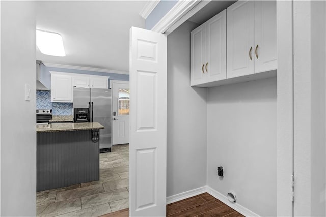 laundry room with hardwood / wood-style floors and ornamental molding