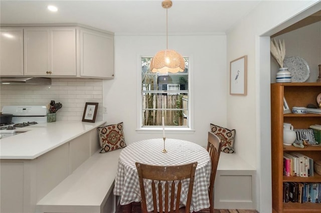 dining space with crown molding and a healthy amount of sunlight