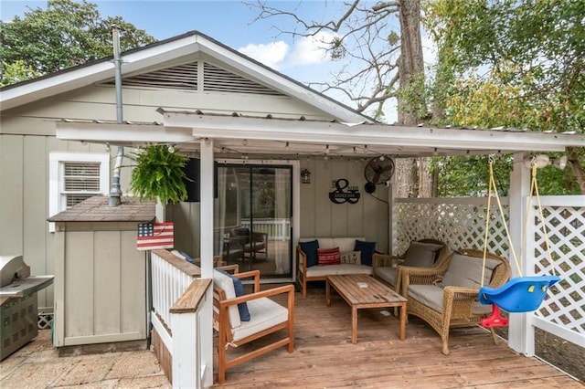 wooden deck with an outdoor living space