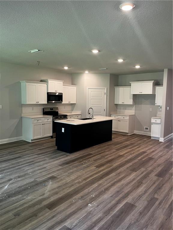 7324 Hawkins Mnr N, Mobile, AL 36695 - kitchen with baseboards, a sink, appliances with stainless steel finishes, a textured ceiling, and dark wood-style flooring