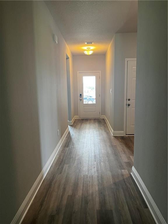 7324 Hawkins Mnr N, Mobile, AL 36695 - corridor featuring dark wood-style flooring, baseboards, and a textured ceiling