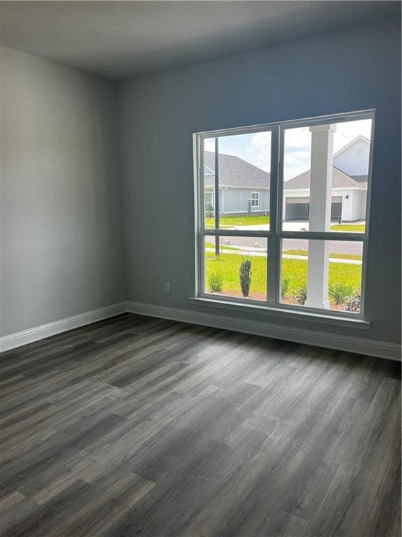 7324 Hawkins Mnr N, Mobile, AL 36695 - spare room featuring baseboards and dark wood-style floors