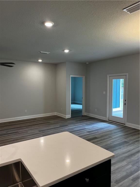 7324 Hawkins Mnr N, Mobile, AL 36695 - kitchen with wood finished floors, a textured ceiling, open floor plan, recessed lighting, and light countertops