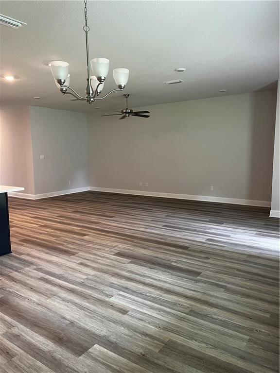 7324 Hawkins Mnr N, Mobile, AL 36695 - unfurnished room with a chandelier and dark wood-style flooring