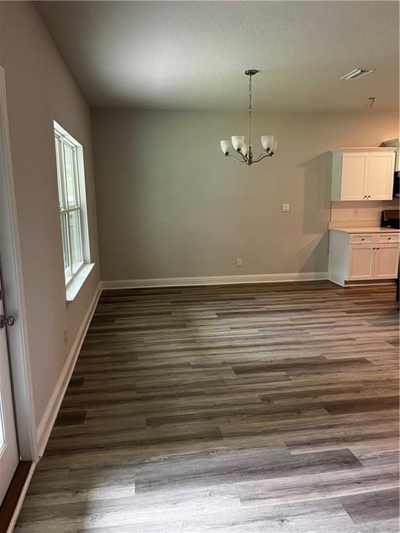 7324 Hawkins Mnr N, Mobile, AL 36695 - unfurnished dining area with a chandelier and dark wood-style flooring