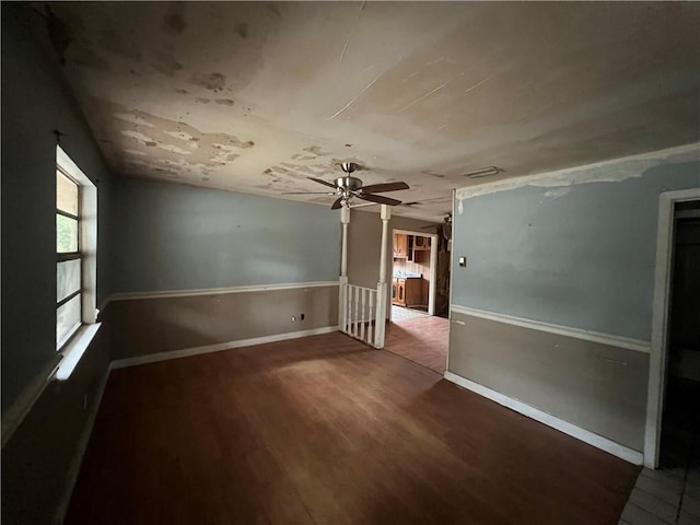 empty room with hardwood / wood-style floors and ceiling fan