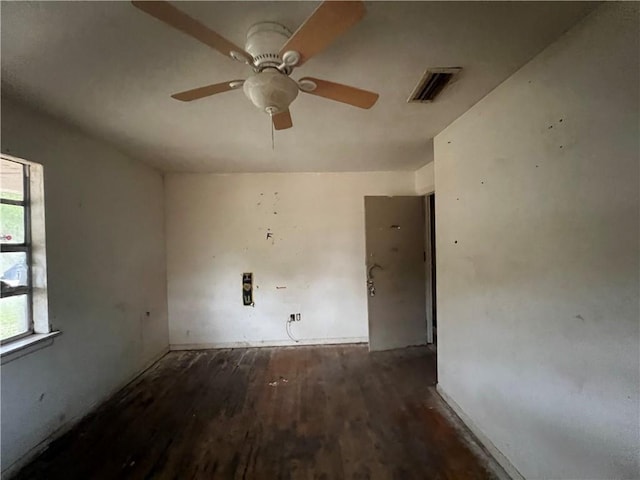 empty room featuring ceiling fan and dark hardwood / wood-style floors