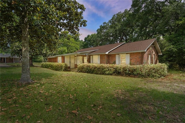 4615 Sunset Dr N, Mobile, AL 36608 - single story home with brick siding, a front lawn, and view of scattered trees