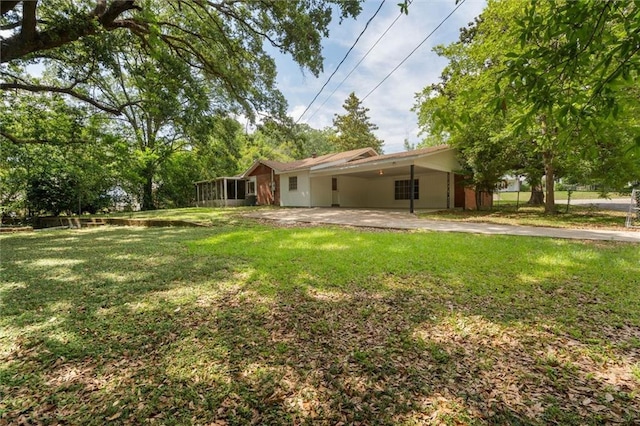 4615 Sunset Dr N, Mobile, AL 36608 - view of green lawn featuring a sunroom, a carport, and a patio