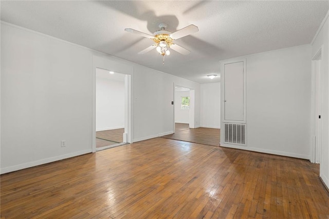 4615 Sunset Dr N, Mobile, AL 36608 - spare room with ceiling fan, hardwood / wood-style floors, baseboards, a textured ceiling, and ornamental molding