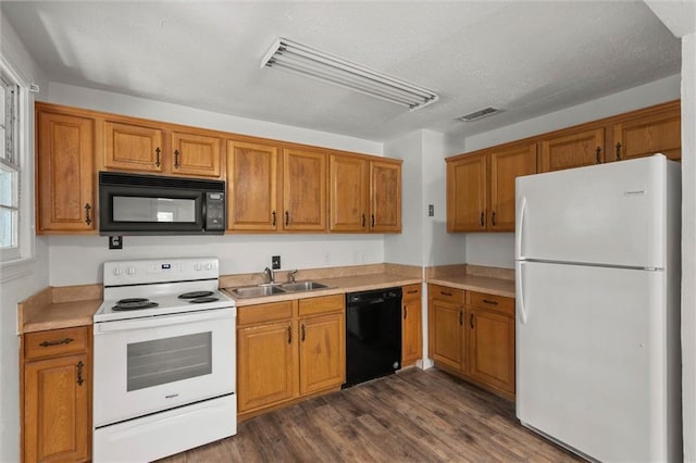 4615 Sunset Dr N, Mobile, AL 36608 - kitchen featuring black appliances, a sink, brown cabinetry, dark wood-type flooring, and light countertops