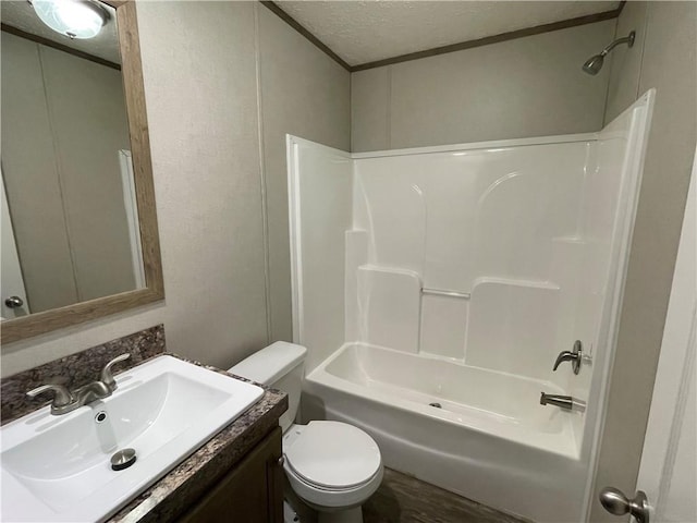 full bathroom with vanity, toilet, shower / bath combination, and a textured ceiling