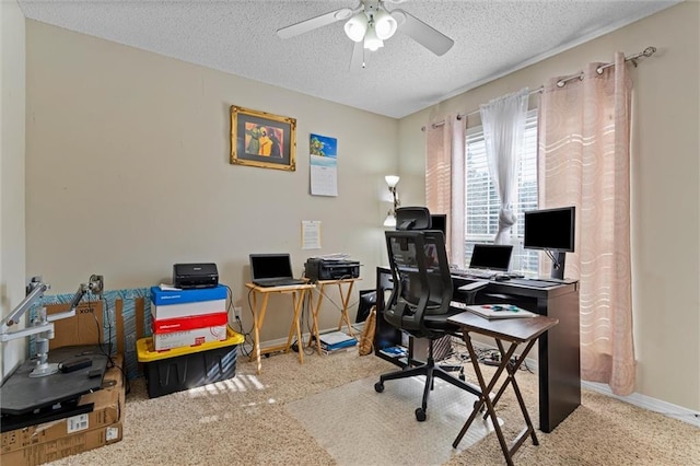 home office with a textured ceiling, ceiling fan, and carpet flooring