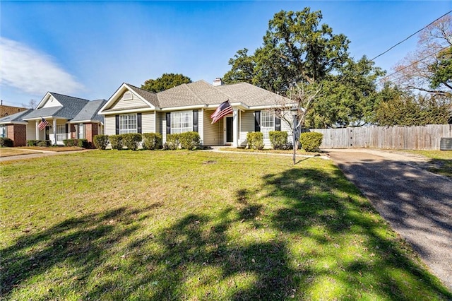 ranch-style home with a front lawn