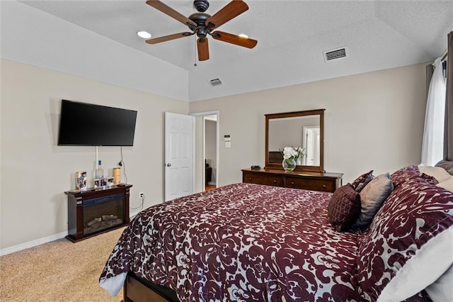 carpeted bedroom featuring ceiling fan and vaulted ceiling