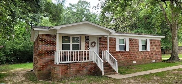 11150 Lakeside Cir, Grand Bay, AL 36541 - bungalow featuring crawl space, brick siding, a porch, and view of scattered trees
