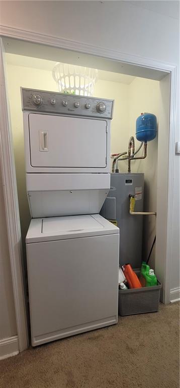 11150 Lakeside Cir, Grand Bay, AL 36541 - laundry area with stacked washer / dryer, electric water heater, and carpet flooring