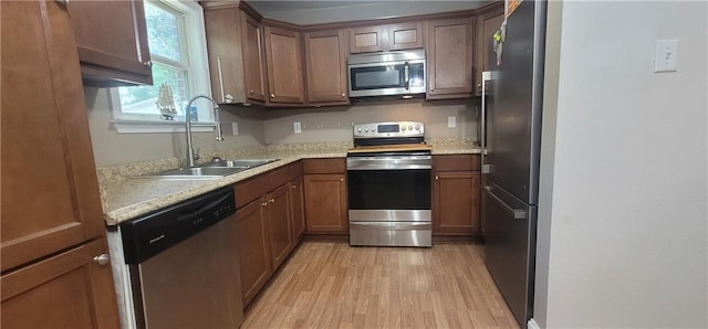 11150 Lakeside Cir, Grand Bay, AL 36541 - kitchen with appliances with stainless steel finishes, light wood-style flooring, light countertops, and brown cabinetry