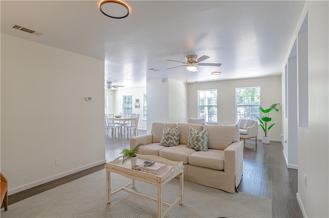 living room with light wood-type flooring and ceiling fan