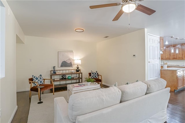 living room with hardwood / wood-style floors and ceiling fan