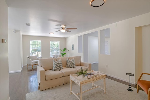 living room featuring ceiling fan and light hardwood / wood-style floors