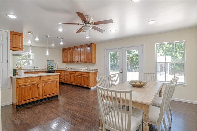 dining space with plenty of natural light, ceiling fan, dark hardwood / wood-style floors, and french doors