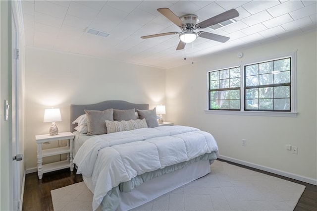 bedroom with ceiling fan and wood-type flooring