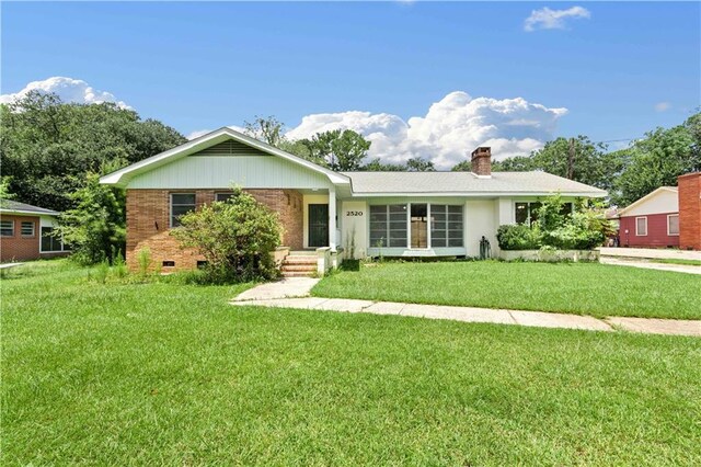 ranch-style house with a front lawn