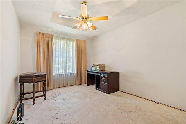 interior space featuring ceiling fan and a tray ceiling