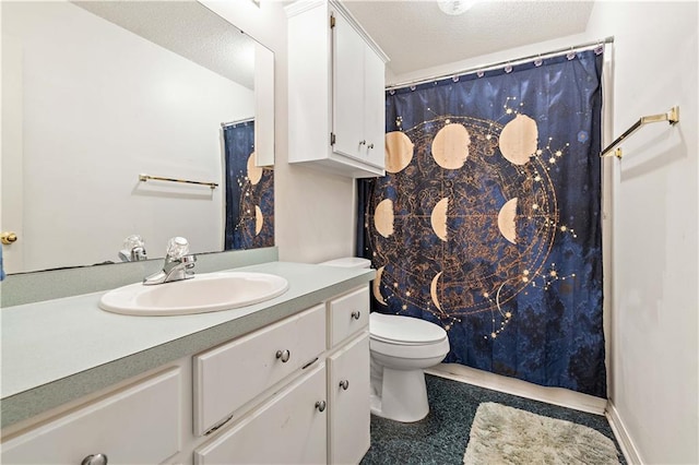 bathroom featuring tile floors, a textured ceiling, toilet, and vanity