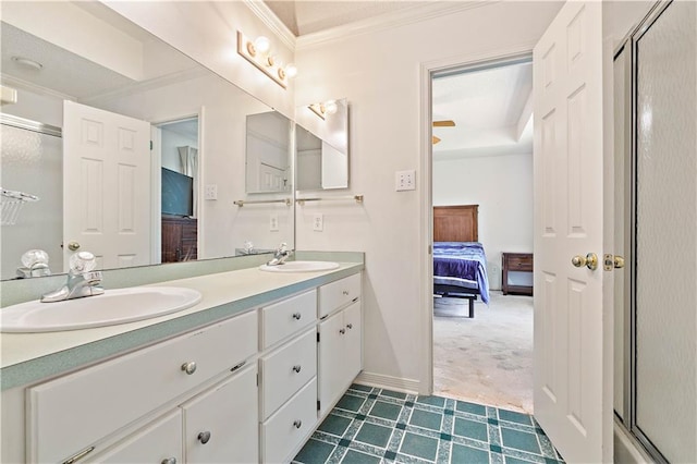 bathroom featuring tile floors, dual sinks, vanity with extensive cabinet space, and crown molding